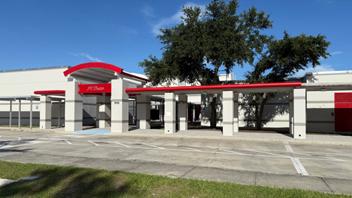 Tampa Florida, Progress Village Middle School's main building, showing the updated entrance with a red roof and clean, white columns.