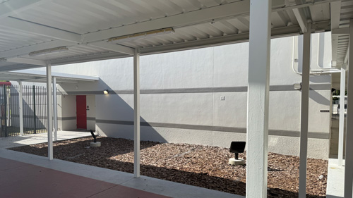 Tampa Florida, A close-up view of a covered walkway and school building, highlighting a new roof installation.